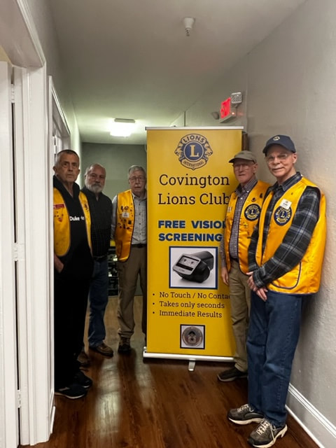 Picture of the Covington Lions Club doing a vision screening at a local church preschool.